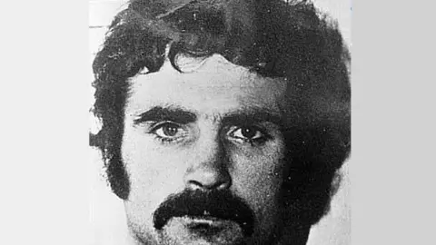 A black and white photo of a young Freddie Scappaticci - he has dark curly hair and a dark moustache
