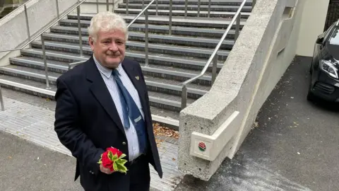 BBC Paul Stewart stands in front of refurbished stairs