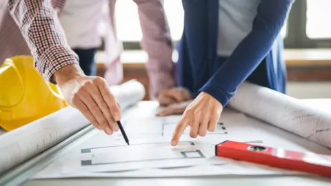 Getty Images people drawing plans