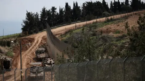 Reuters Israeli military vehicles move along the Israeli side of the Israel-Lebanon border, 2 March 2026