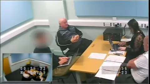 Neil Foden sat in custody being interviewed by the police