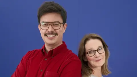 Susie Dent stans next to Phil Wang