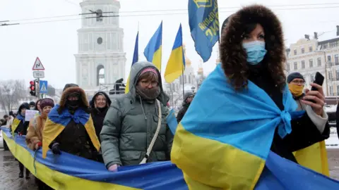 Getty Images People hold a 500m(1640ft)-long flag of Ukraine in Sofiiska Square running towards Mykhailivska Square on Unity Day, Kyiv, capital of Ukraine.