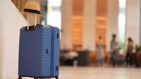 Getty Images A suitcase in a hotel lobby