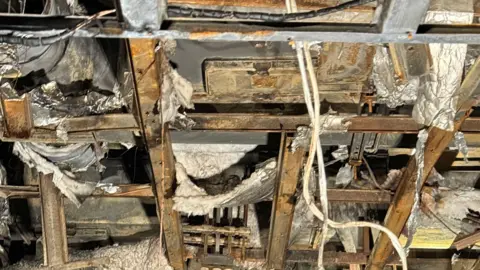 University Hospital Southampton A ceiling has been destroyed, revealing the metallic structure of the building. Strips of insulation have been torn and burnt. 