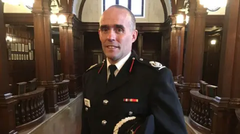 Local Democracy Reporting Service A man in uniform - a mainly black jacket, white shirt and black tie. 