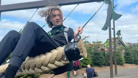 Claire Catherall Ryan Catherall on a swing