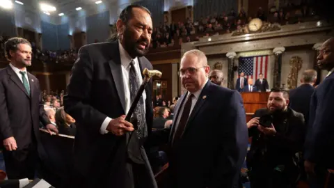 US Representative Al Green (D-TX) is removed from the chamber after shouting out as US President Donald Trump