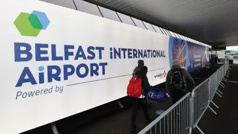 PA Media Passengers at Belfast International Airport