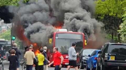 bus in flames on street