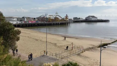 Getty Images A general view of the long Clacton Pier, with its various rides and amusements on it, and the beach.