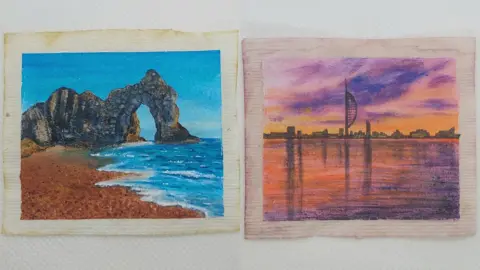 PA Media Two flattened teabags - one has Durdle Door with grey rocks, golden sand and bright, blue sea painted on it, while the other has the Spinnaker Tower in silhouette with a purple and orange sky reflected in the water painted on it