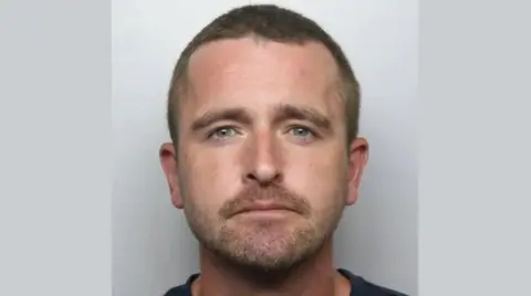 Staffordshire Police Police mugshot of Simon Orr, who is facing the camera and wearing a dark-coloured top