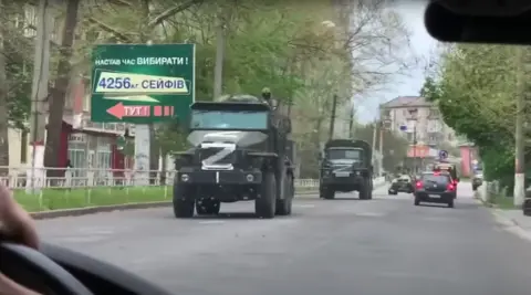 Konstantin.S Large Russian Trucks with white Z painted on them drive down a street