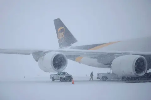 Getty Images A UPS cargo jet sits parked in the snow at Louisville Muhammad Ali International Airport on 5 January 2025 