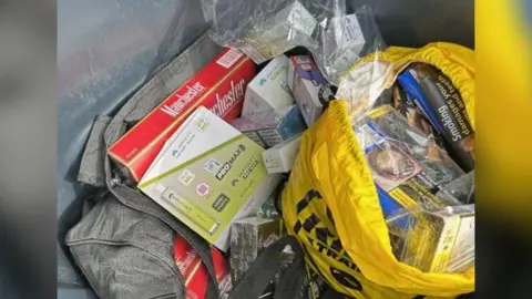 Darlington Borough Council A black holdall and a yellow drawstring bag contain illegal vapes and large packs of tobacco.