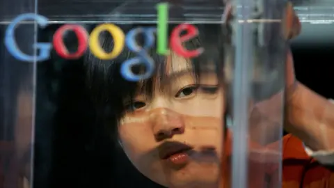 Getty Images A Chinese woman's face appears behind a Google logo