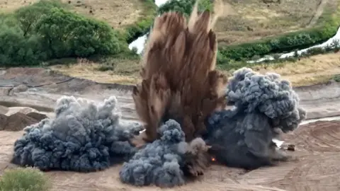 Close up of bomb being blown up in quarry