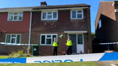 PA Media Police stood in front of an address on Lovett Avenue in Oldbury 