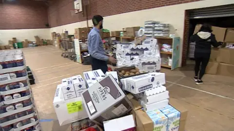 BBC A sports hall in Beeston which is used as a warehouse to store food parcels