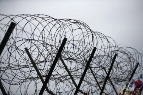 AFP/Getty Images Barbed wire fence at the Imjingak, near the Demilitarized zone (DMZ) separating South and North Korea on 14 April 2017 in Paju, South Korea.