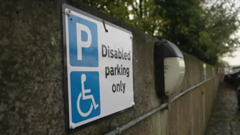 BBC A blue and white sign saying Disabled Parking Only