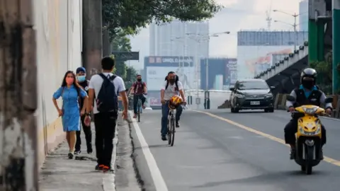 European Photopress Agency People walk and ride bicycles to work along a highway in Makati, Philippines, 04 August 2020.