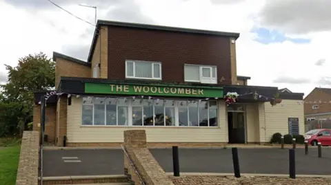 The entrance of the Woolcomber pub.