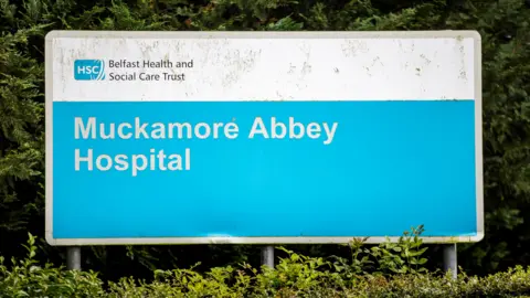 PA Media A blue sign that says Muckamore Abbey Hospital 
