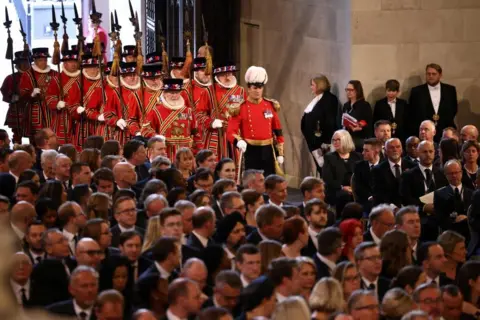 Henry Nicholls/Pool/Reuters Royal guards walk in Westminster Hall,