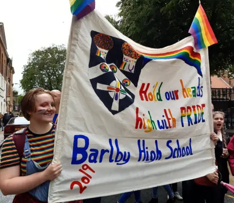 Barlby History Students holding a homemade Pride banner