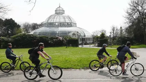 Getty Images People cycle past Victorian Palm House in Sefton Park