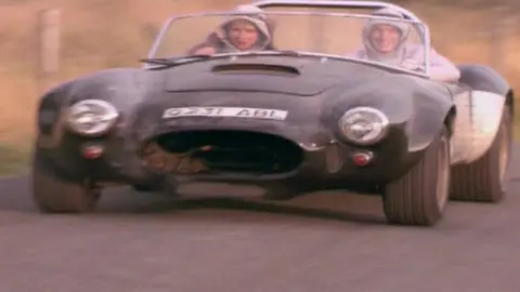 Twin Town/Figment Films/Agenda/Kevin Allen The Lewis twins driving an AC Cobra