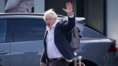 PA Media Boris Johnson arrives at Gatwick Airport in London, after travelling on a flight from the Caribbean