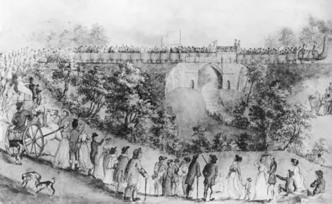 Getty Images/Hulton Archive Sketch by John Dobbin of crowds gathered to watch the opening of the Stockton and Darlington Railway in 1825