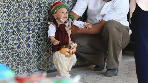 Tunisian families bring their children for annual circumcision feast tradition at Sidi Sahab Zawiya and Madrasa ahead of Laylat al-Qadr in Kairouan, Tunisia on June 11, 2018