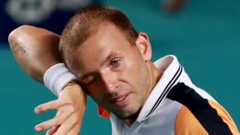 Dan Evans wipes his face while playing at the Mexican Open in 2024