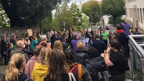 Campaigners against the proposal to exempt small businesses gathered outside the States in 2022