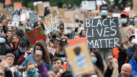 Getty Images Protesters hold up placards in Cardiff