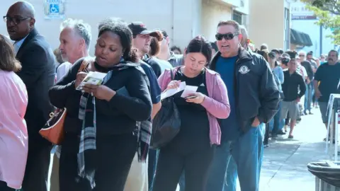 Getty Images A line of people waiting for lottery tickets