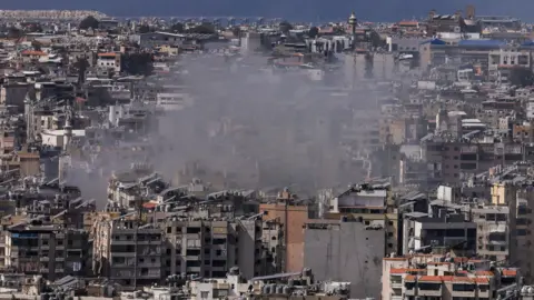 Reuters Smoke rises from Beirut's southern suburbs following Israeli strikes on Lebanon (12 March 2026)