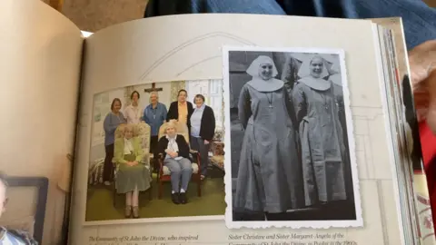 A black and white picture of two nuns in traditional habits in a book. Next to the photo is another picture, in colour, of a group of older women with two seated, in a room.