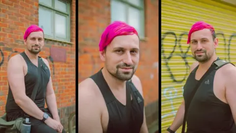 Jamie O'Neill Images of man with pink hair standing beside a wall in Portsmouth