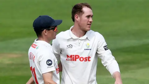 Ben Kellaway of Glamorgan (R) celebrates taking the wicket of Graeme van Buuren of Gloucestershire