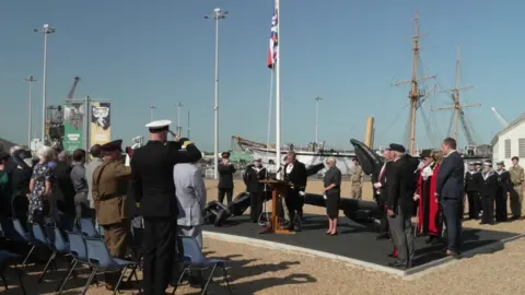 Charlotte Wright/BBC Veterans, military personnel and residents attended the VJ Day commemoration at the Historic Chatham Dockyards in Kent.
