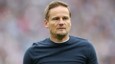 Neal Ardley looks on