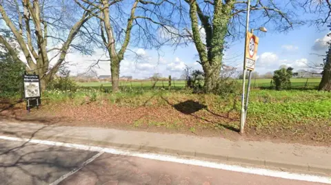 Google A Google street view image from a rural road showing a field behind a fence and some trees. A 30mph sign is on the right and on the left is a "welcome to Albrighton" sign.