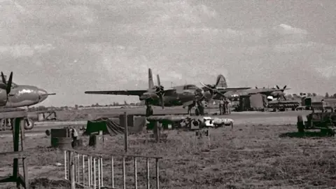Supplied A black and white photo of planes on an airfield.