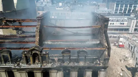 The charred remains of a former department store gutted by fire