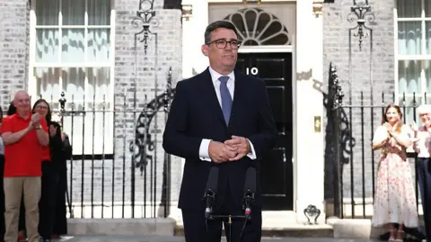 Getty Images Andy Burnham outside Number 10. He is wearing a dark suit and blue tie